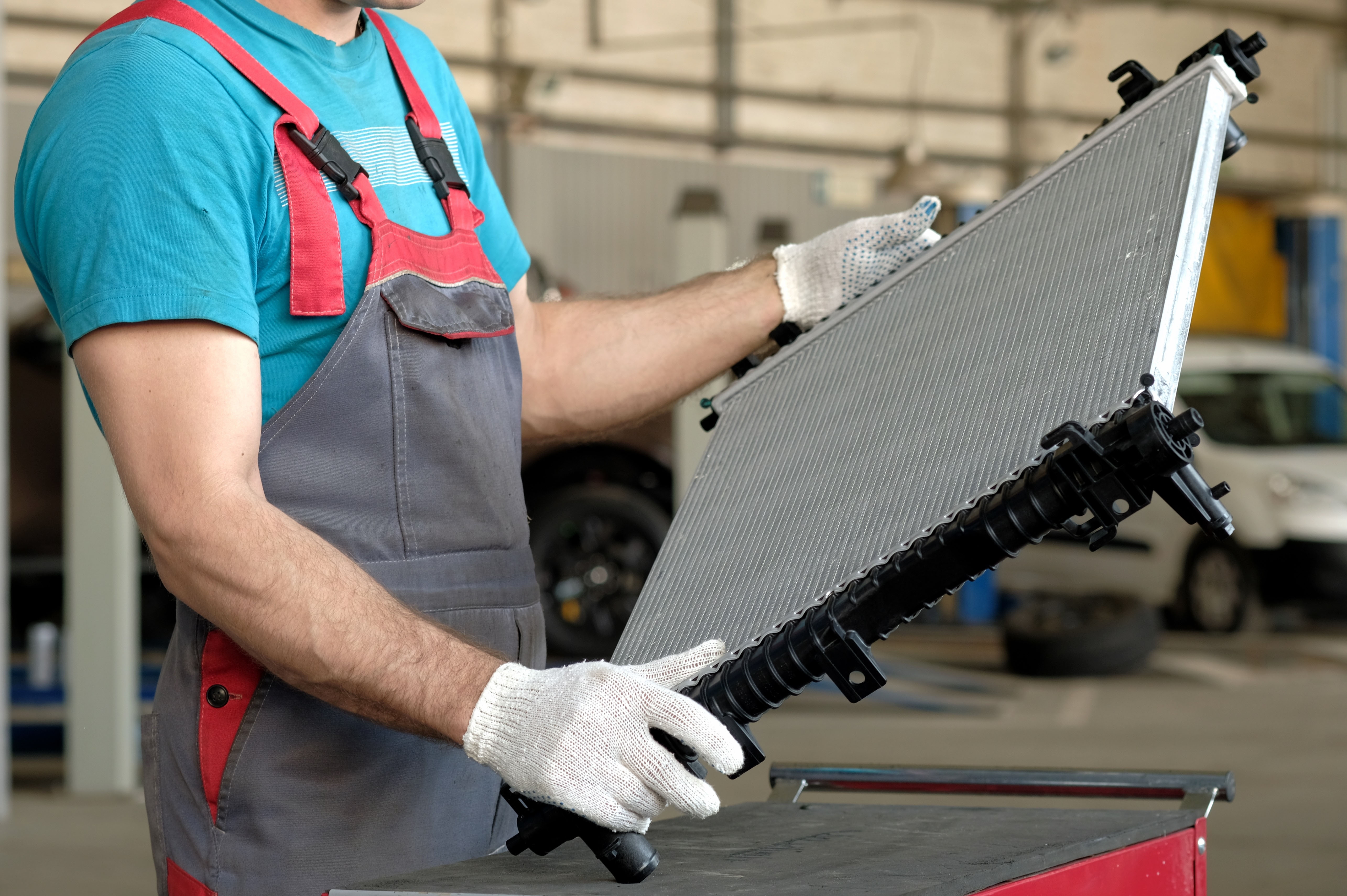 Engine Cooling Radiator Is In The Hands Of An Auto Mechanic